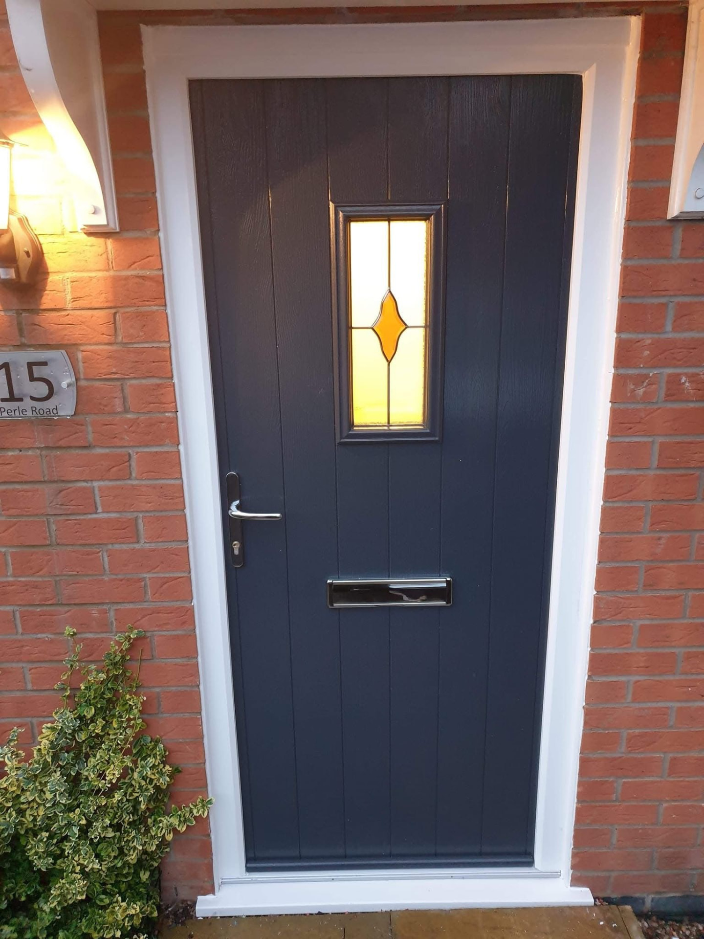 Anthracite grey plank-style composite door with diamond window installed in Staffordshire