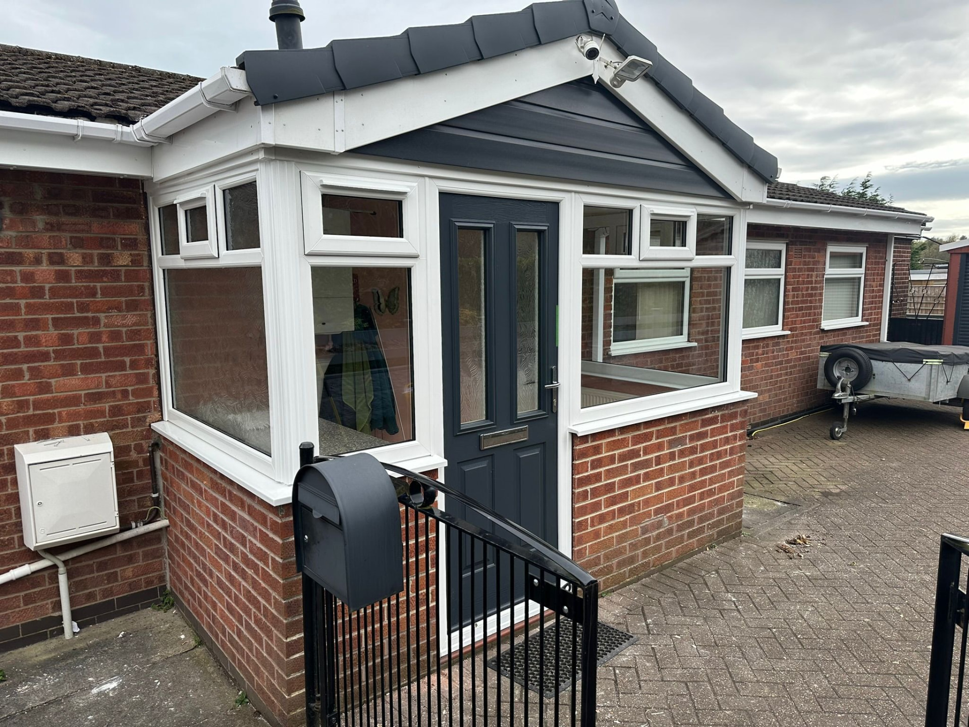Brick porch with white uPVC windows and an anthracite grey composite door