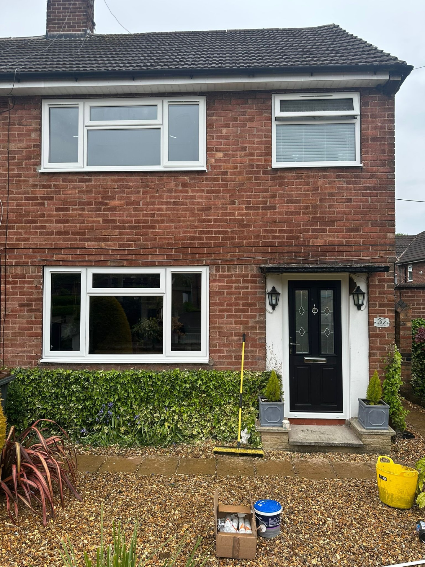 Red brick semi-detached house with new white uPVC windows and black composite door