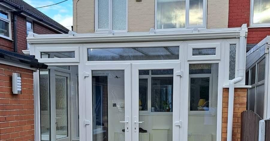 White uPVC French doors with matching side panels on a modern extension