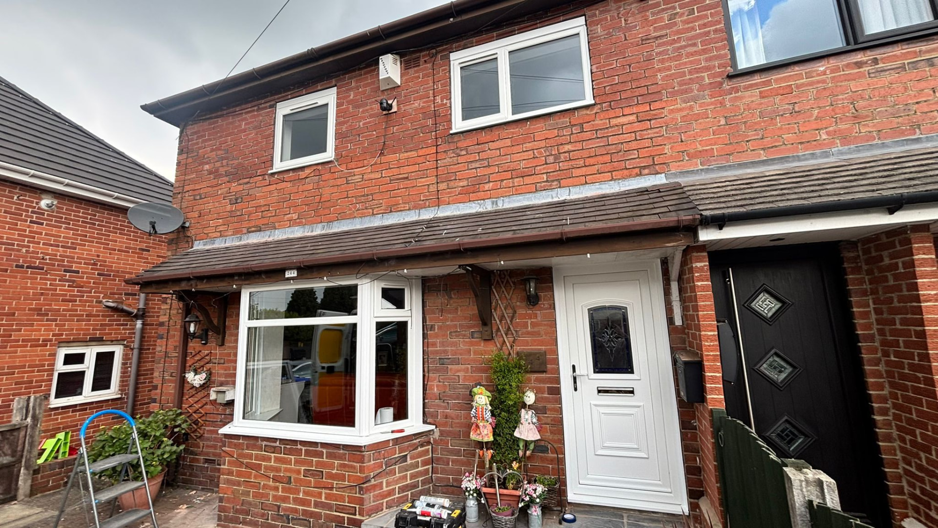 Red brick home fitted with new energy efficient white uPVC windows and composite door