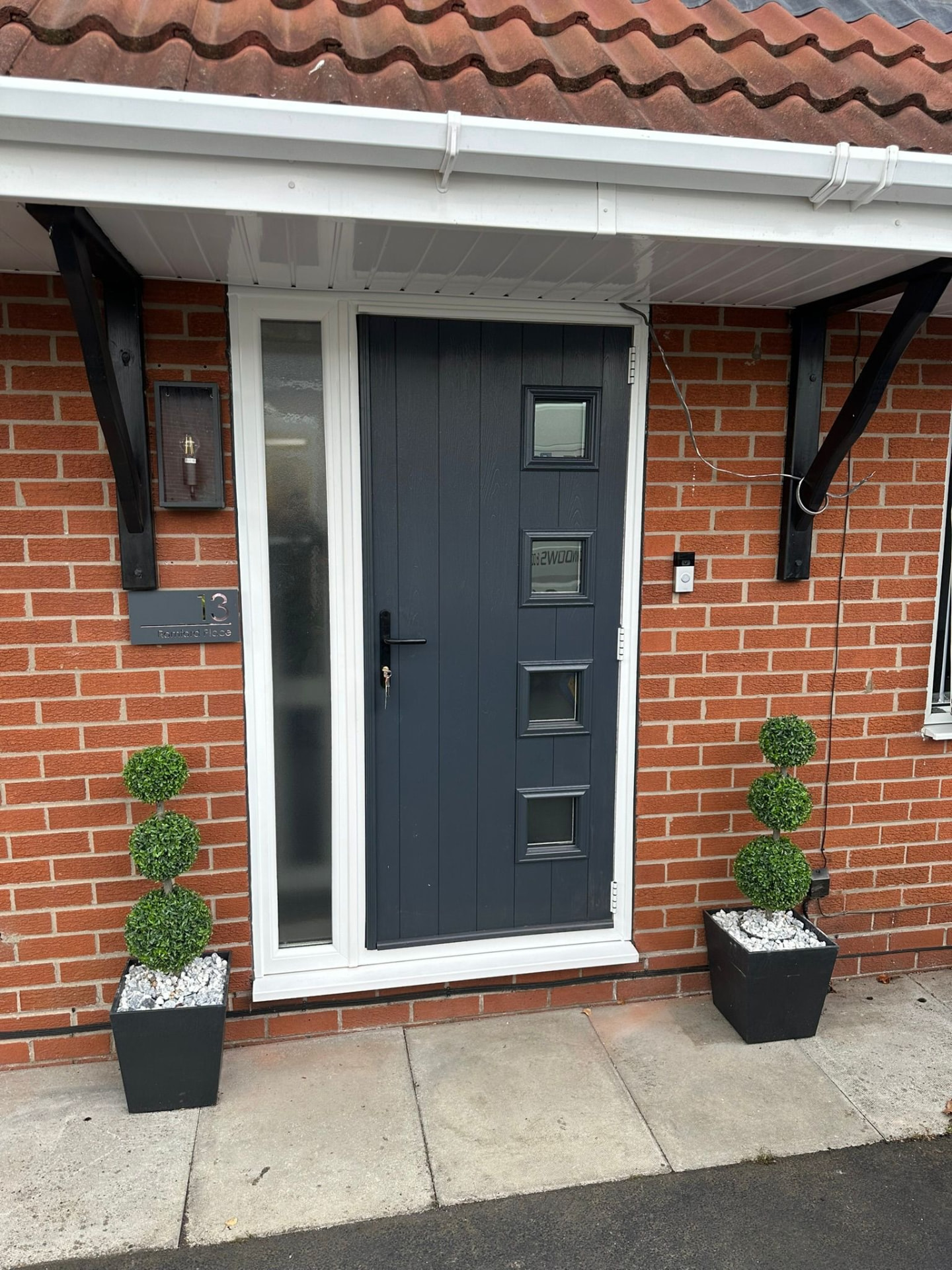 Contemporary grey composite door with square windows and frosted side panel installed in Staffordshire