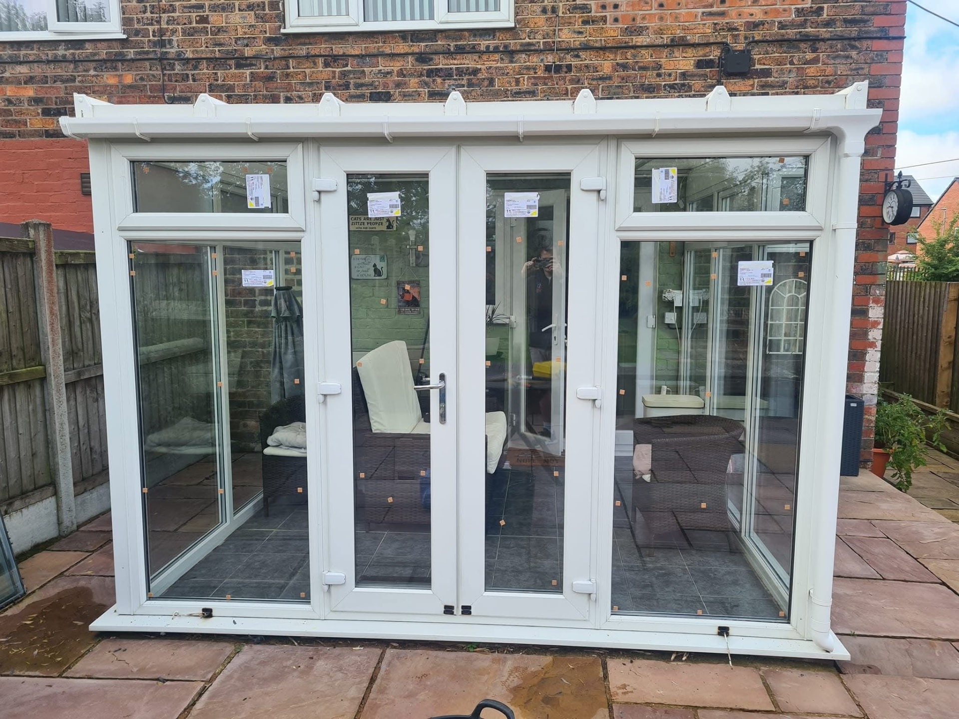 Newly installed white uPVC French doors with protective film still on the glass