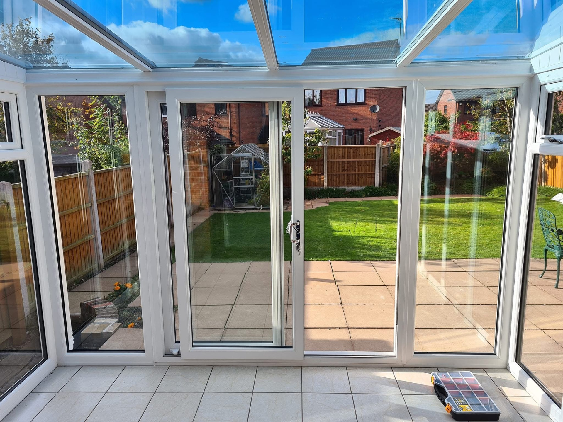 White uPVC sliding patio door viewed from a conservatory overlooking the garden