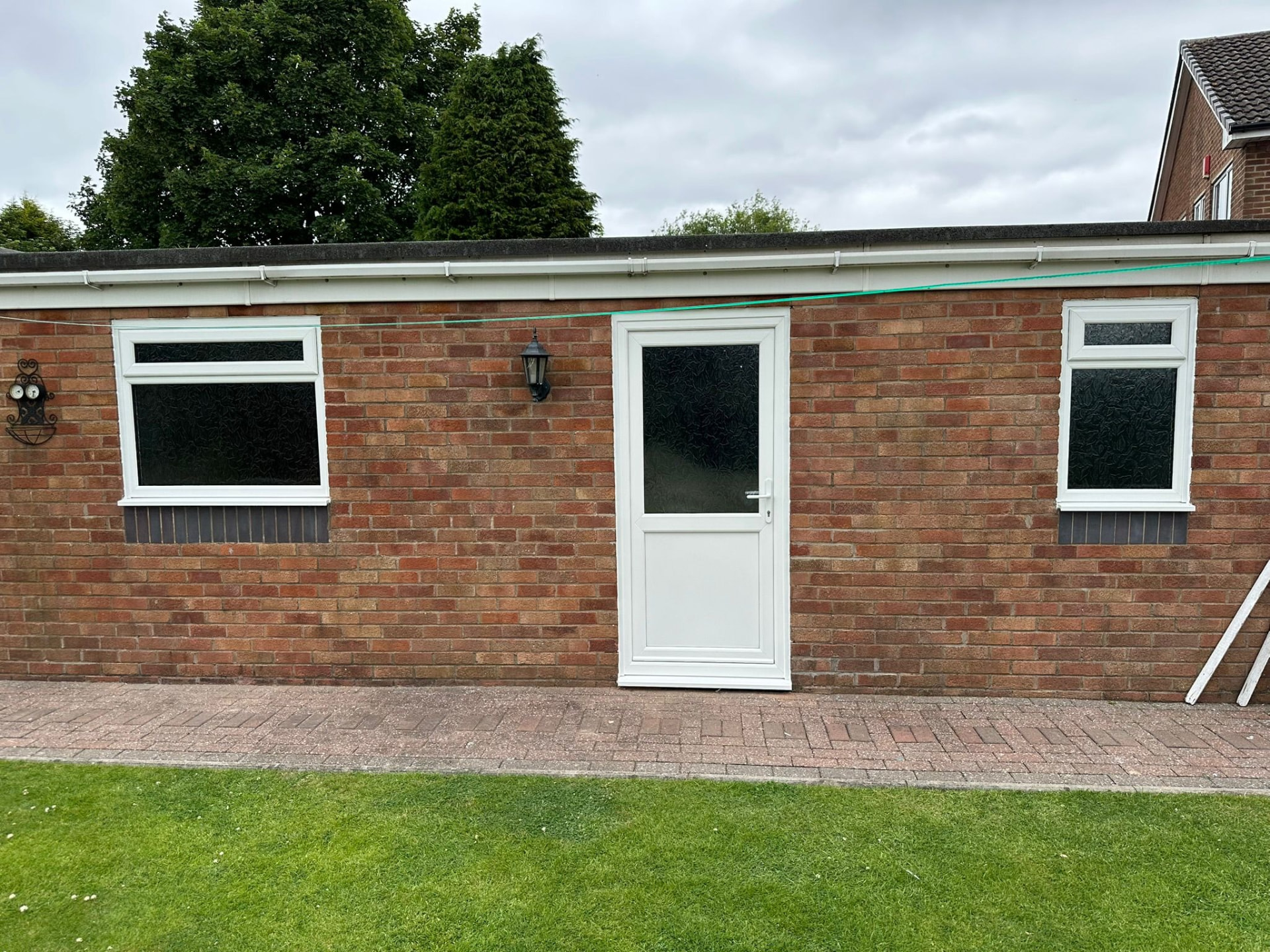 Row of white uPVC windows and door fitted to a brick outbuilding in Staffordshire