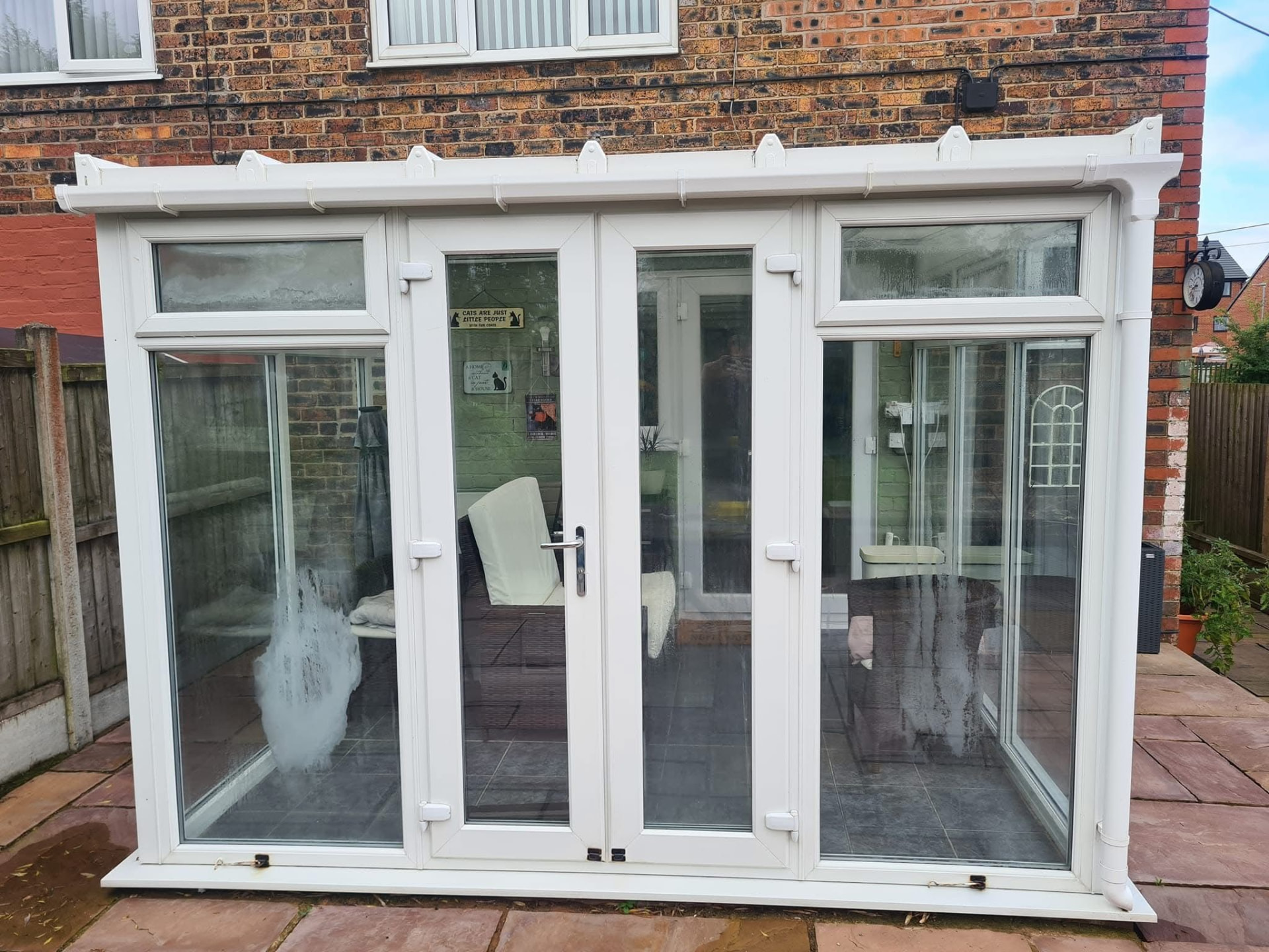 White uPVC conservatory on a red brick home with stone tiled base in Staffordshire